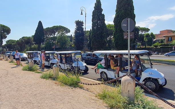 Golf carts with tourists on a guided tour in Rome, Italy.