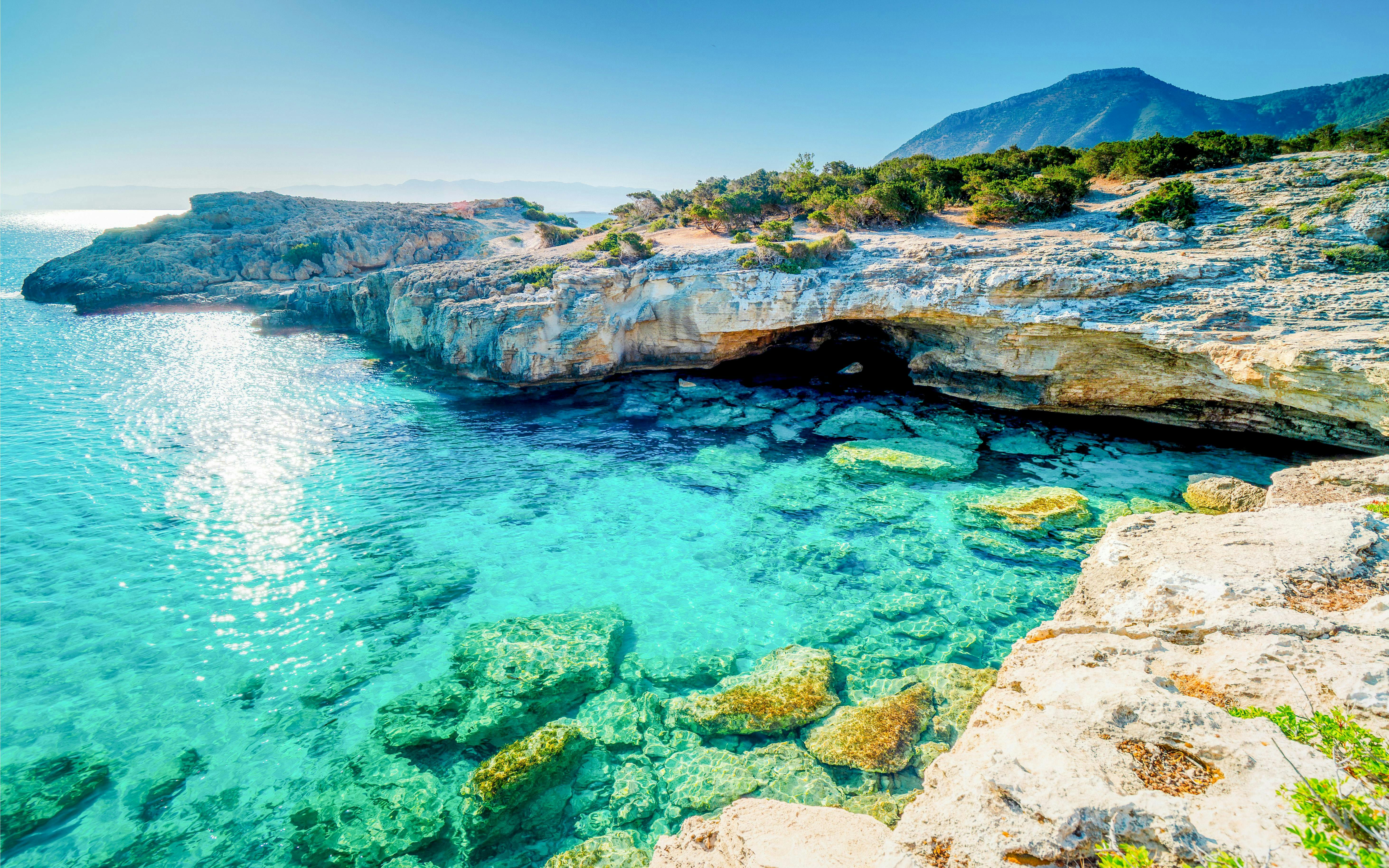 Turquoise waters and rocky cliffs at Manolis Bay, Akamas Peninsula, Cyprus.