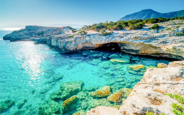 Turquoise waters and rocky cliffs at Manolis Bay, Akamas Peninsula, Cyprus.