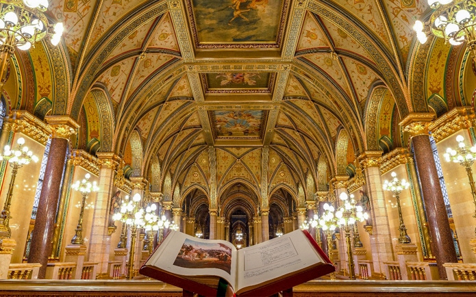 Hungarian Parliament interior with ornate ceiling and open book, Budapest audio tour.