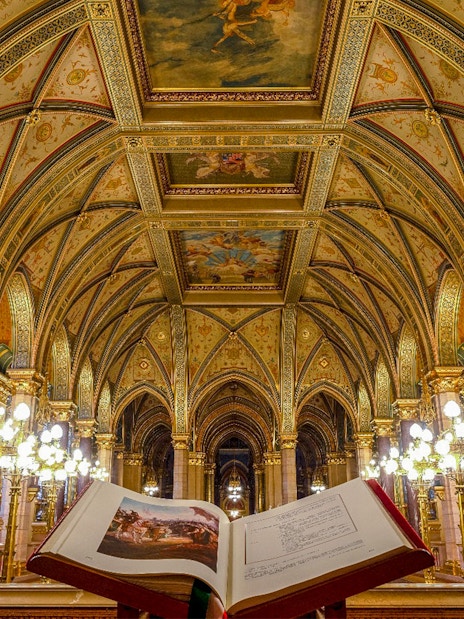 Hungarian Parliament interior with ornate ceiling and open book, Budapest audio tour.