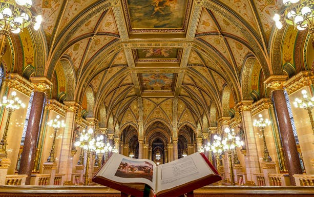 Hungarian Parliament interior with ornate ceiling and open book, Budapest audio tour.