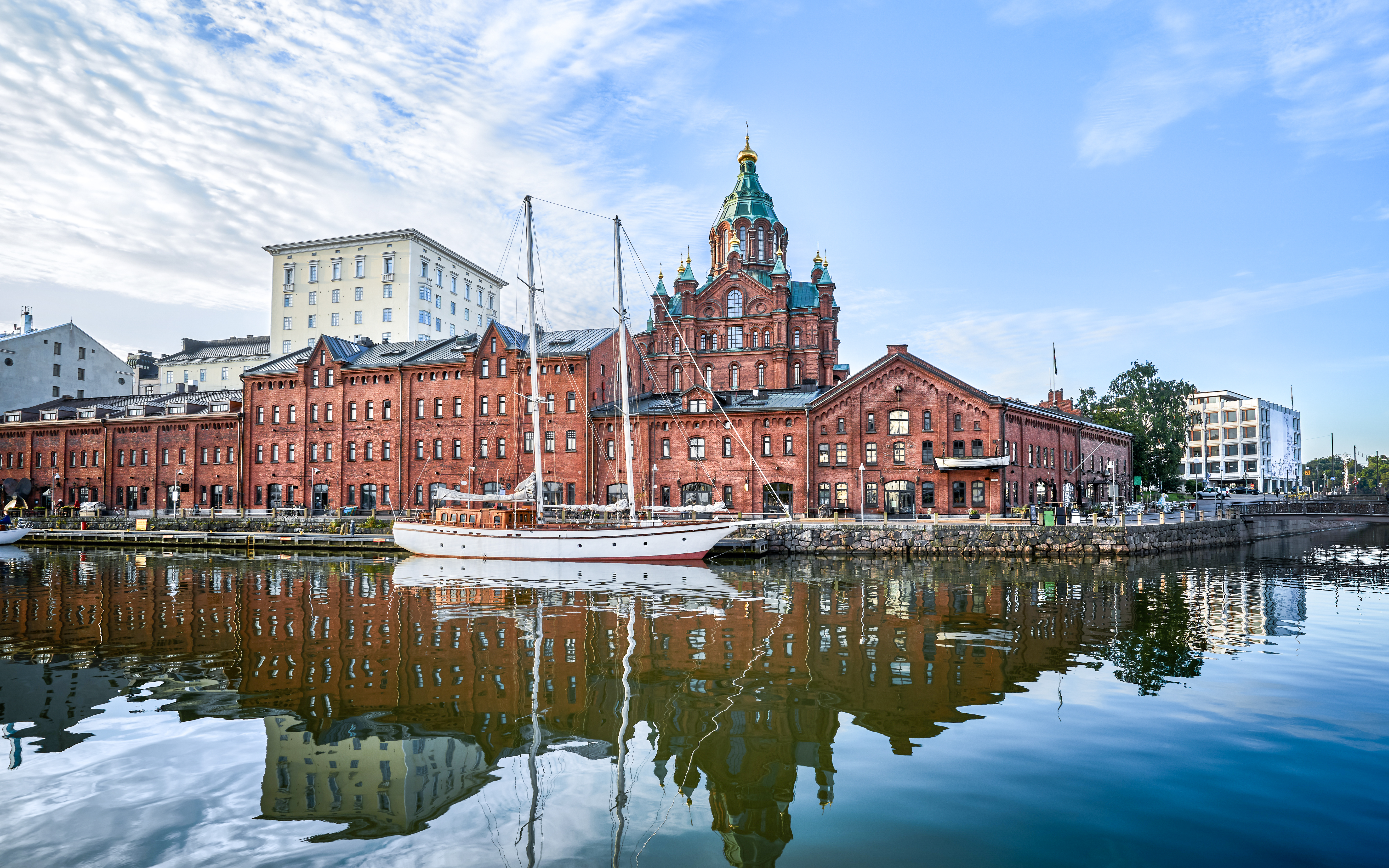 Seaside view of Uspenski Cathedral and red brick buildings in Helsinki, Finland.