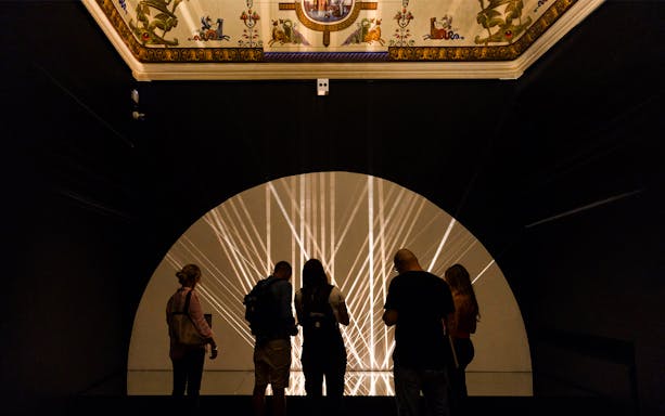 Visitors viewing light installation at Palazzo delle Papesse temporary exhibition.
