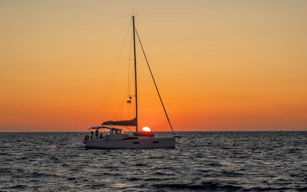 Sailboat on the Aegean Sea during a Santorini sunset cruise.