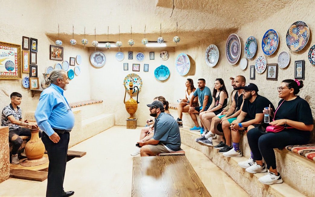 Pottery workshop demonstration in Avanos with visitors observing handcrafted ceramics.