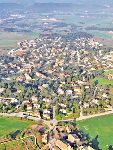 Aerial view of countryside village and fields from hot air balloon ride.