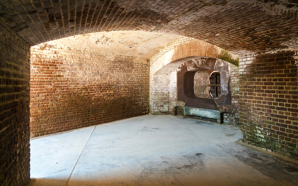Interior of Fort Sumter National Monument showing historic brick walls and arched openings.