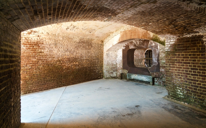 Interior of Fort Sumter National Monument showing historic brick walls and arched openings.