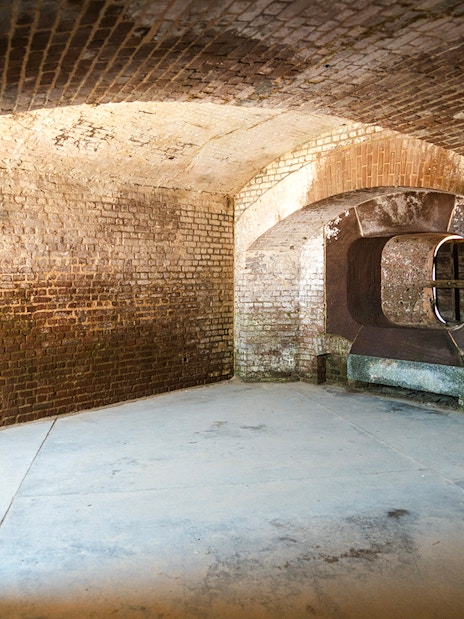 Interior of Fort Sumter National Monument showing historic brick walls and arched openings.
