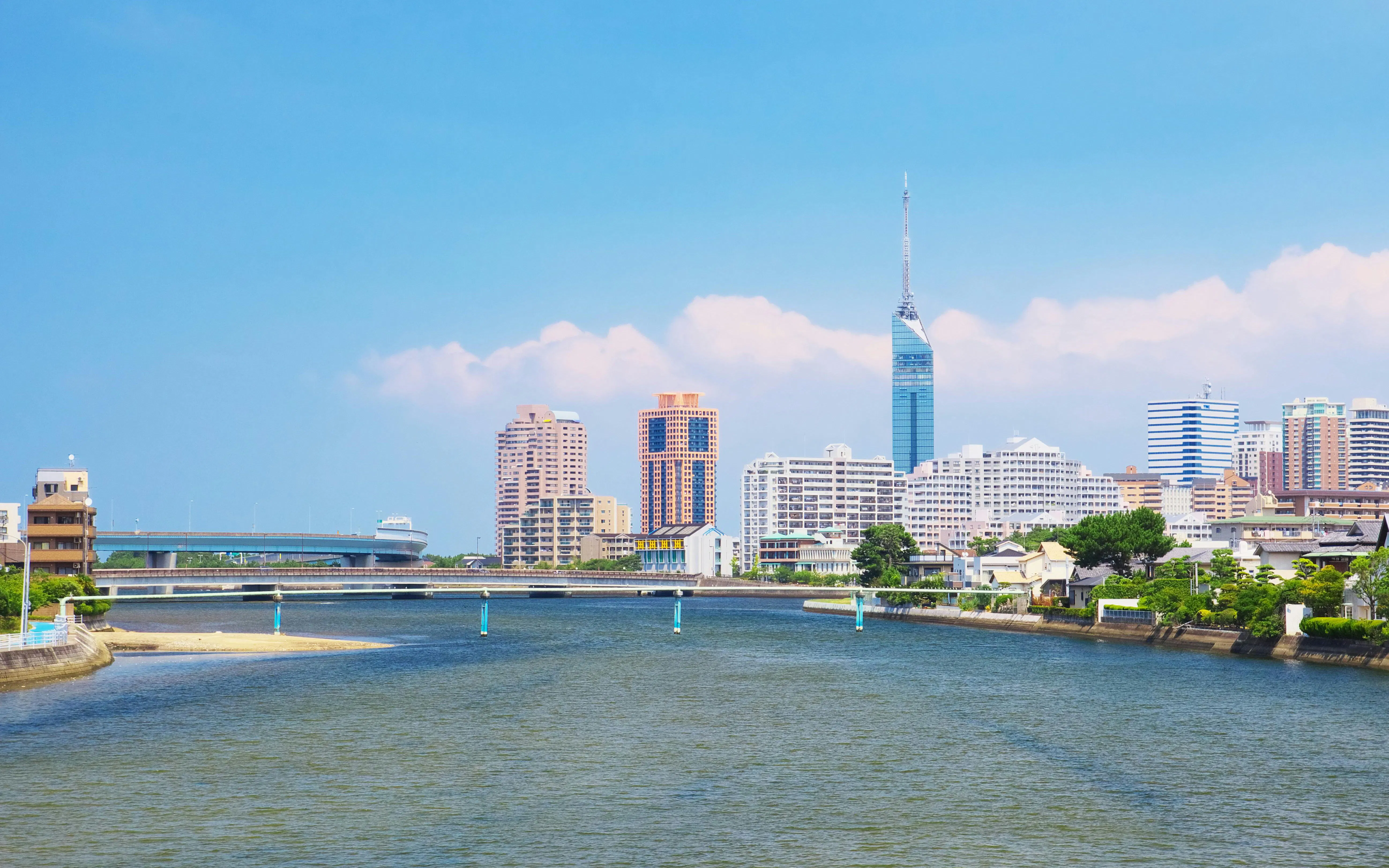 Fukuoka Tower and city skyline along Muromi River in Fukuoka, Japan.