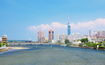 Fukuoka Tower and city skyline along Muromi River in Fukuoka, Japan.