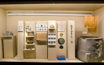 Medieval artifacts display inside Bratislava Castle, featuring sculptures, manuscripts, and relics.