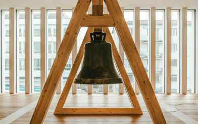 Bell installation inside Kunsthaus Zürich museum with large windows in the background.