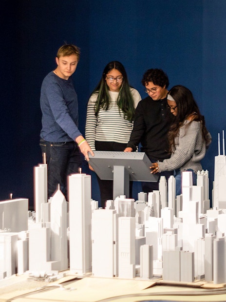 Guests interacting with a city model at the Chicago Architectural Center exhibit.