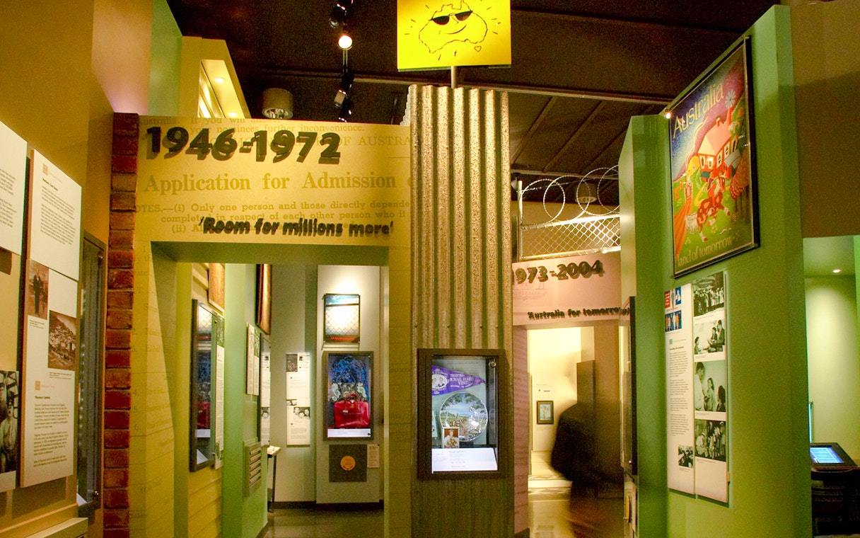 Interior exhibits at Immigration Museum showcasing historical admission periods.