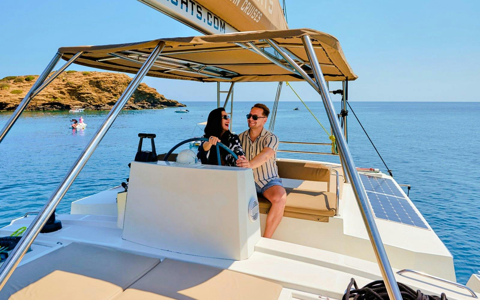 Guests steering catamaran during Ierapetra to Chrissi Island cruise.
