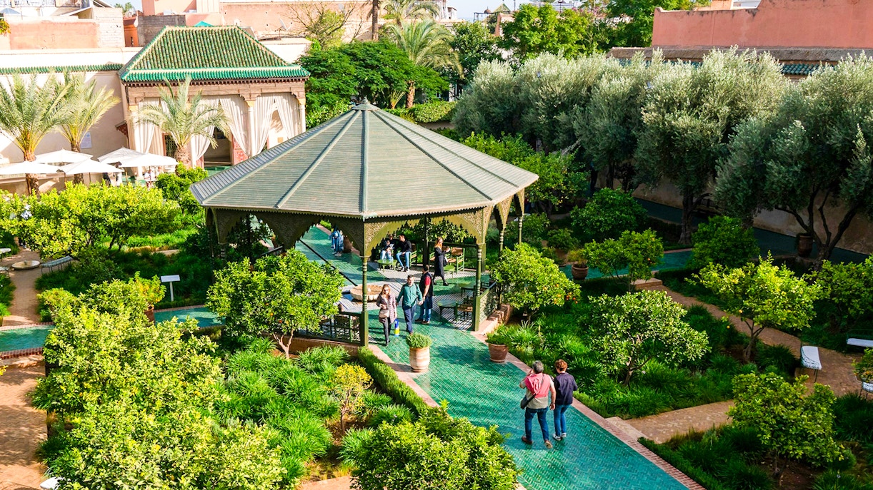 Jardin Secret garden with gazebo and visitors in Marrakech, Morocco.