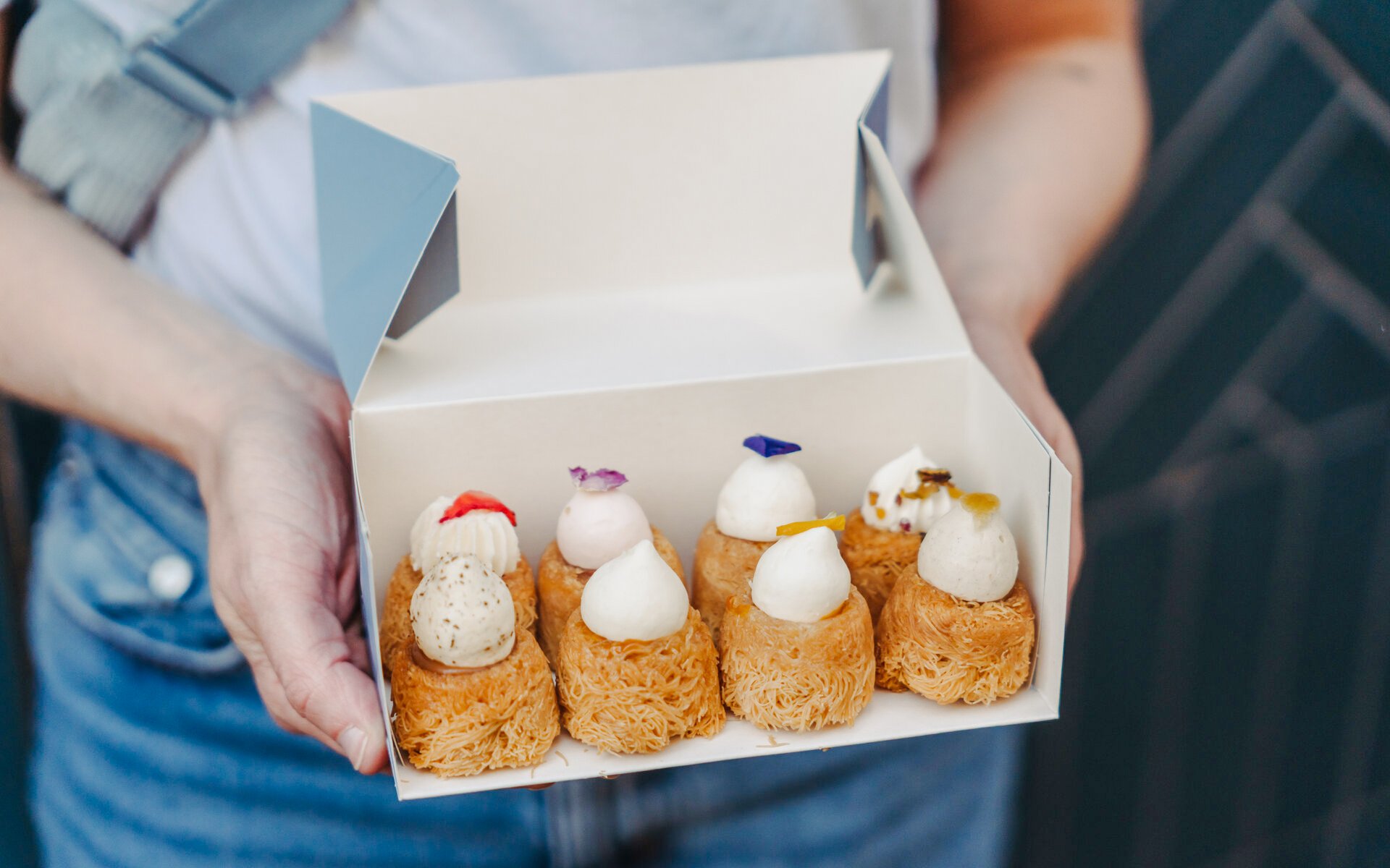 Assorted Parisian pastries in a box, part of the Ultimate Paris Food Tour.