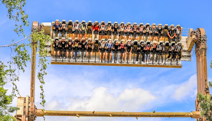 Tourists on Pulsar ride at Walibi Belgium, experiencing thrilling water splash.