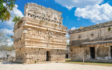 Temple with intricate carvings at Chichen Itza, Mexico, showcasing Mayan architecture.