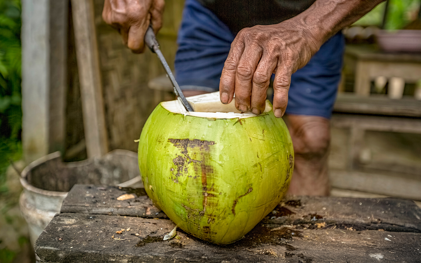 Man slicing coconut in Bali.