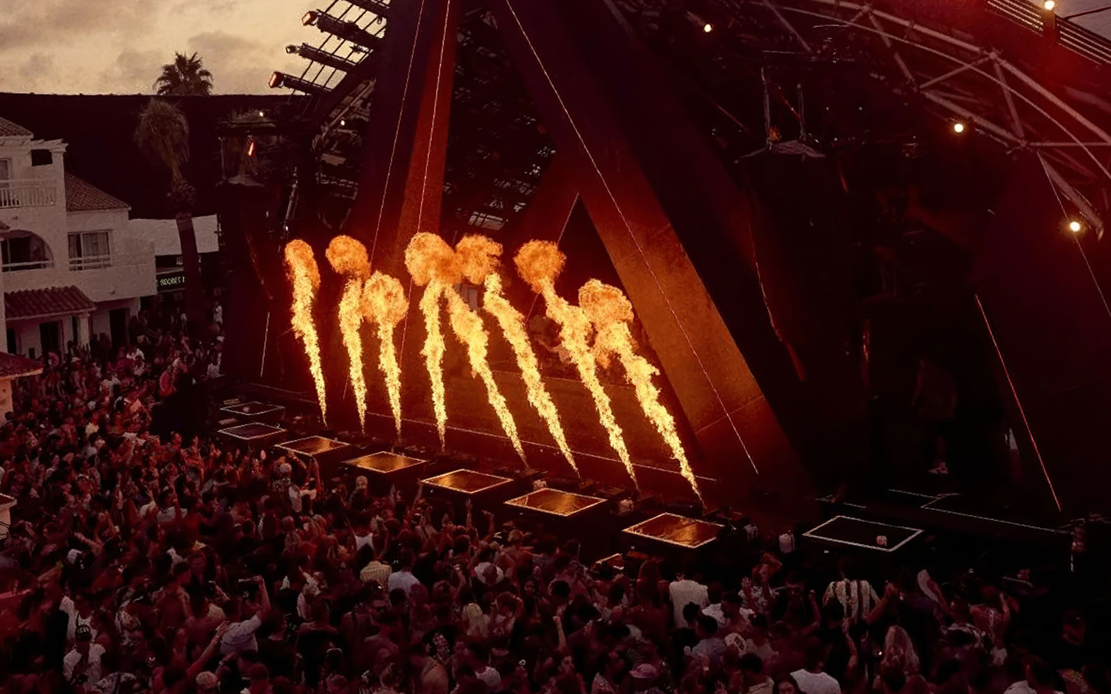 Fire display during Ants Ushuaïa performance in Ibiza with crowd watching.