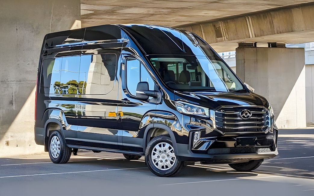 Luxury transfer bus for Great Ocean Road Reverse Tour parked under a bridge.