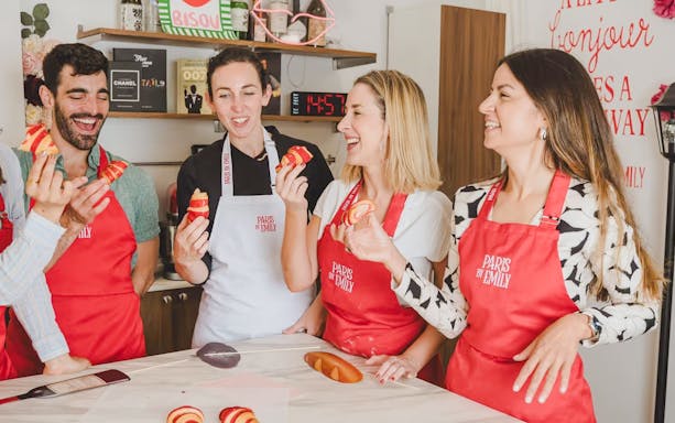People enjoying croissant-making at Emily in Paris workshop.