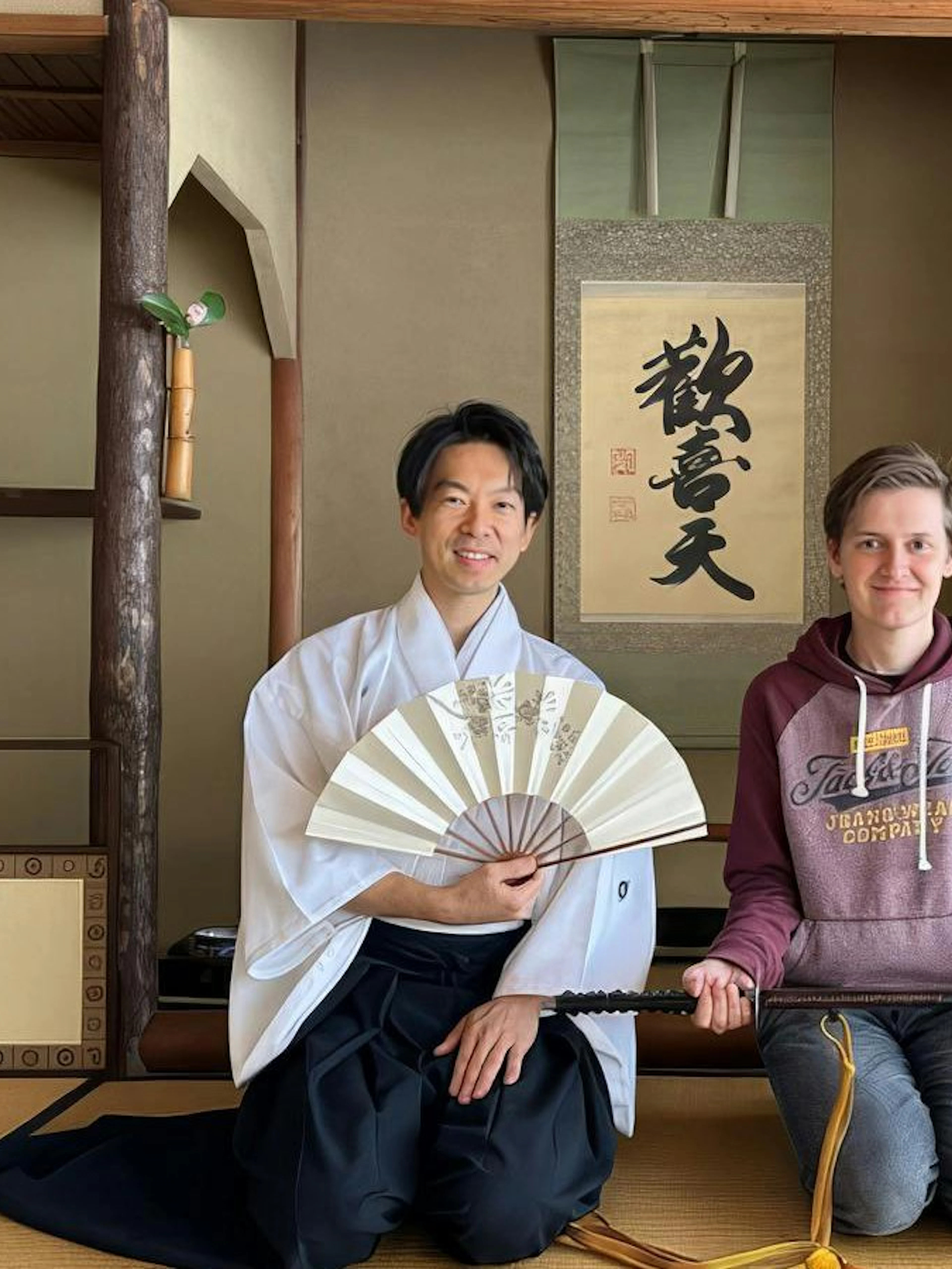Guests at Osaka samurai sword training in a traditional Japanese room.
