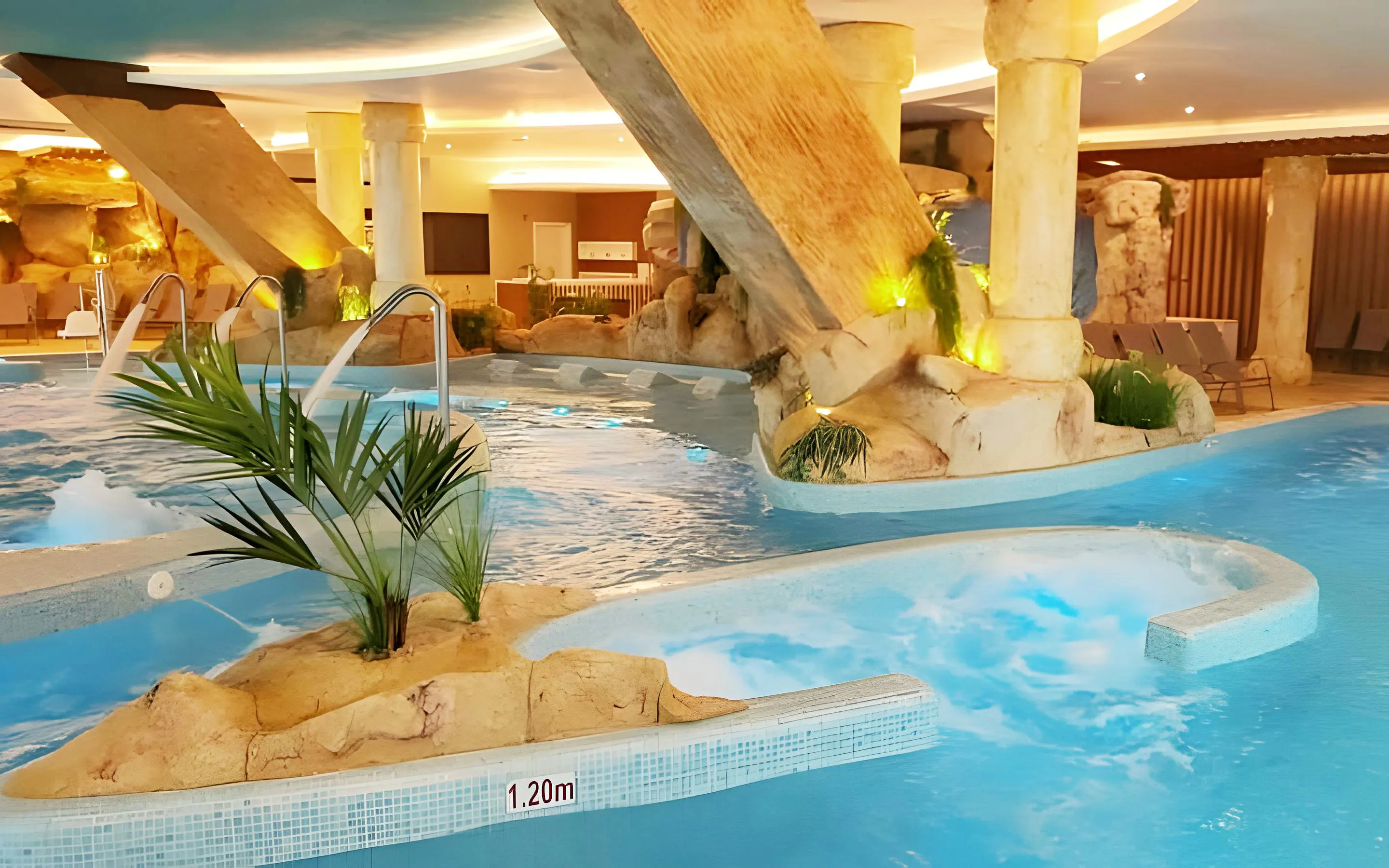 Indoor water park with pools and rock formations at Aquashow Indoor Park.