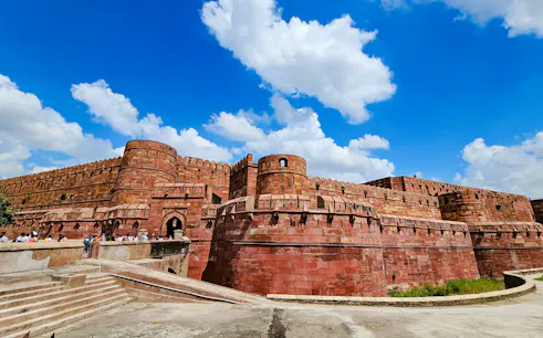 Agra Fort with red sandstone walls under blue sky, part of 2 Days Delhi & Agra Private Tour.