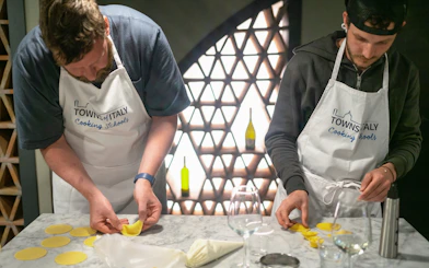 Participants making pasta at a Milan cooking class.