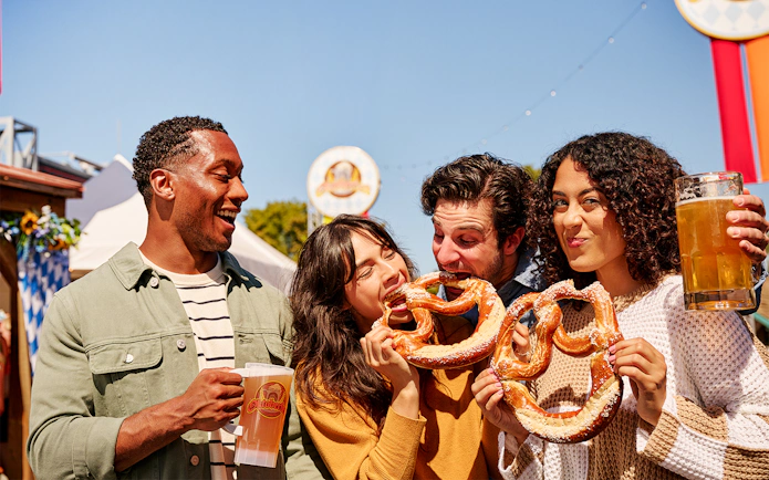 Friends enjoying pretzels and beer at Oktoberfest event, Canada's Wonderland, Six Flags.