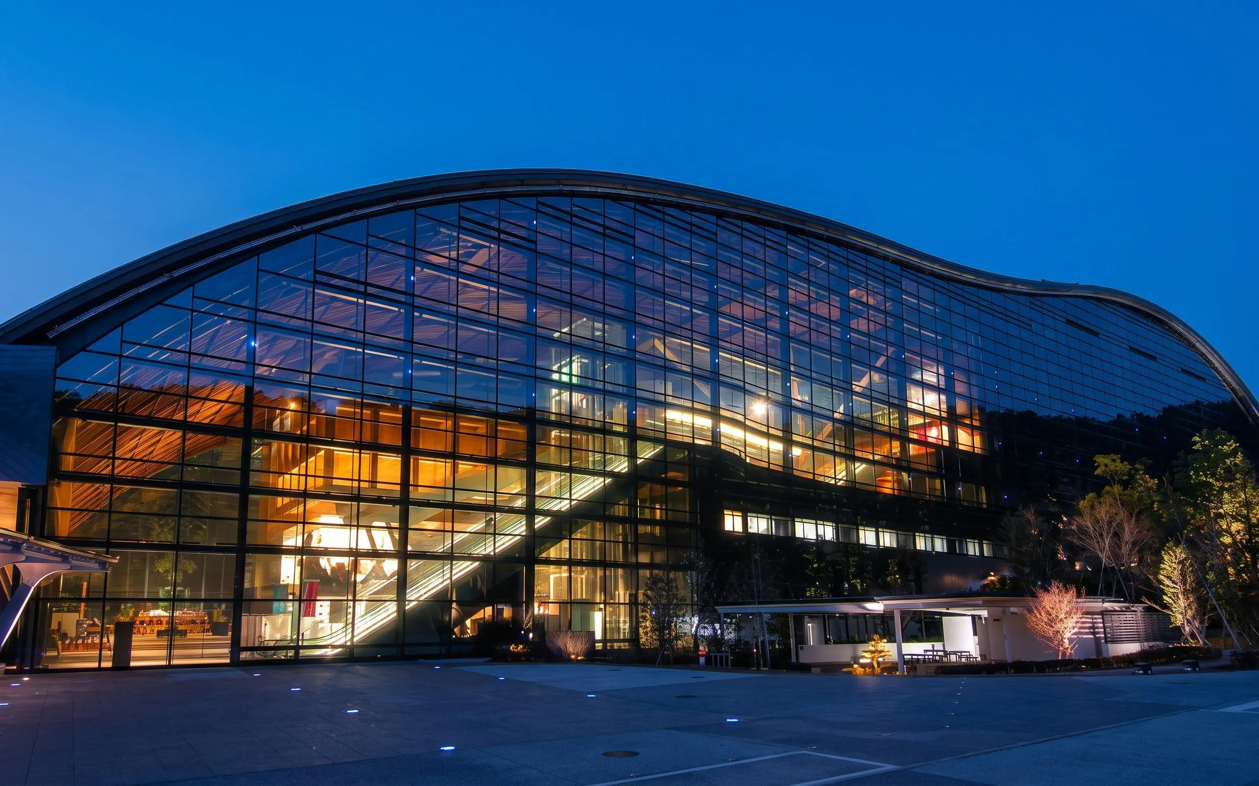 Kyushu National Museum glass facade illuminated at night, Japan.