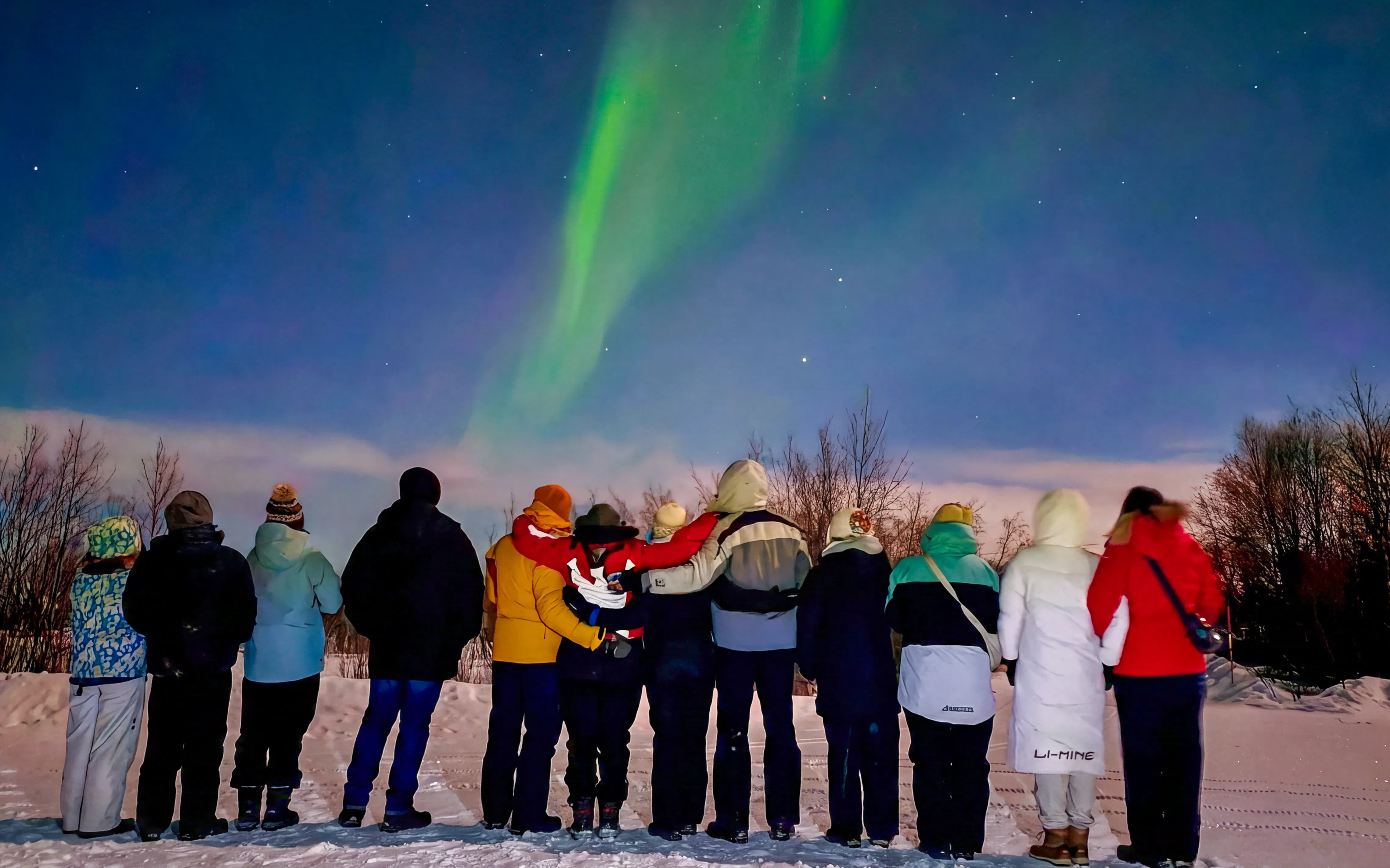 Group watching northern lights in Kiruna, Sweden.