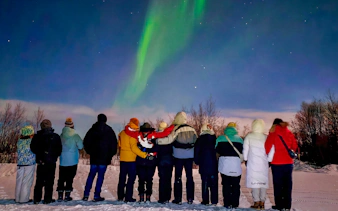 Group watching northern lights in Kiruna, Sweden.