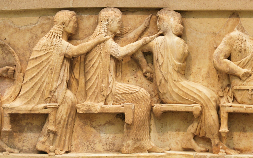 Ancient Greek relief sculpture depicting seated figures at Delphi.