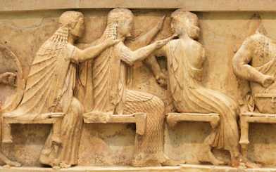 Ancient Greek relief sculpture depicting seated figures at Delphi.