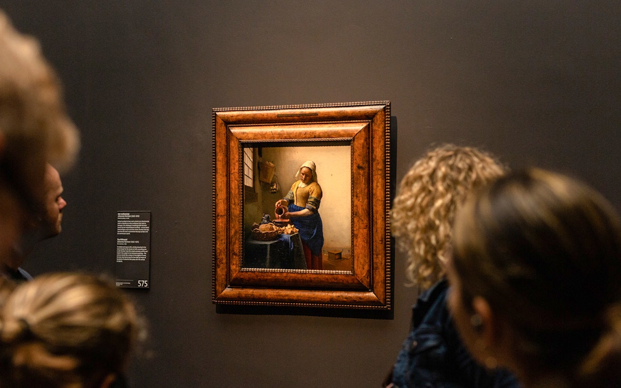 Visitors viewing Vermeer's "The Milkmaid" at the Rijksmuseum in Amsterdam.