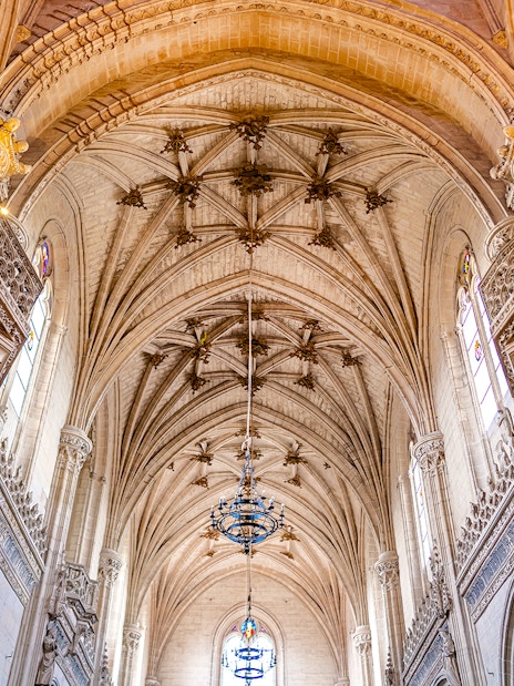 Gothic interior of Toledo Cathedral with ornate arches and detailed carvings.