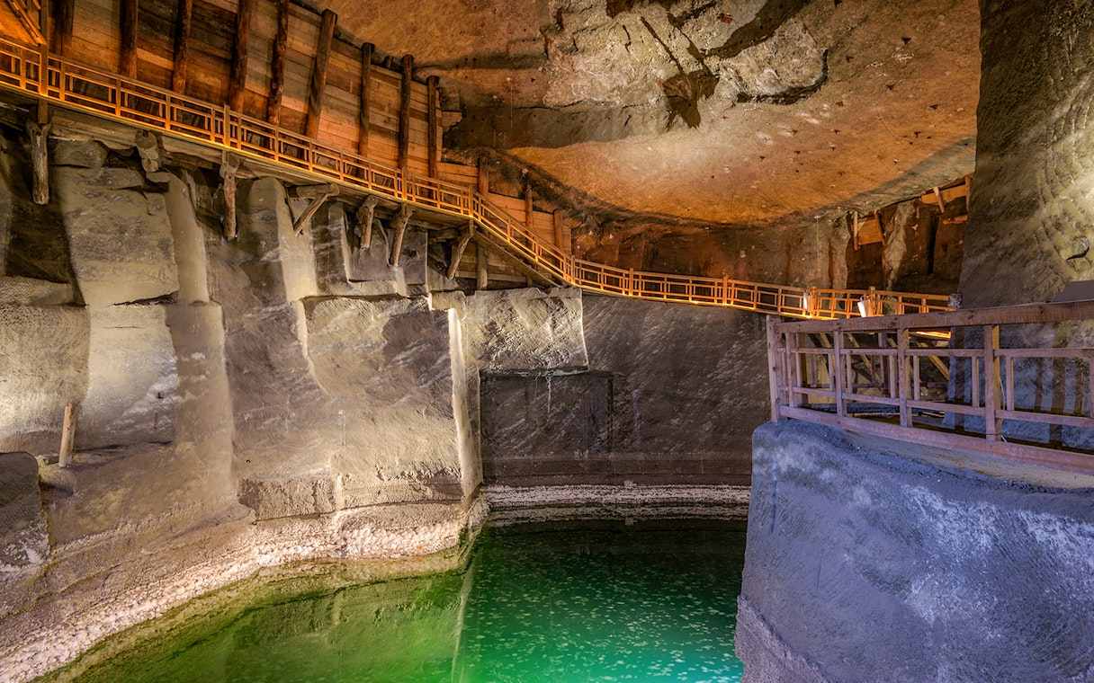 Wieliczka Salt Mine chamber with wooden walkways and illuminated salt formations, Krakow tour.