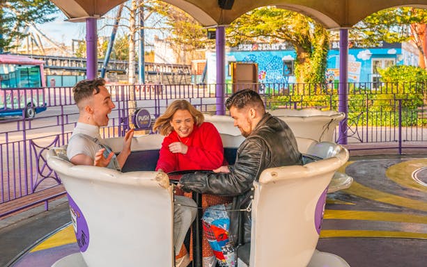 People enjoying a teacup ride at Thorpe Park.