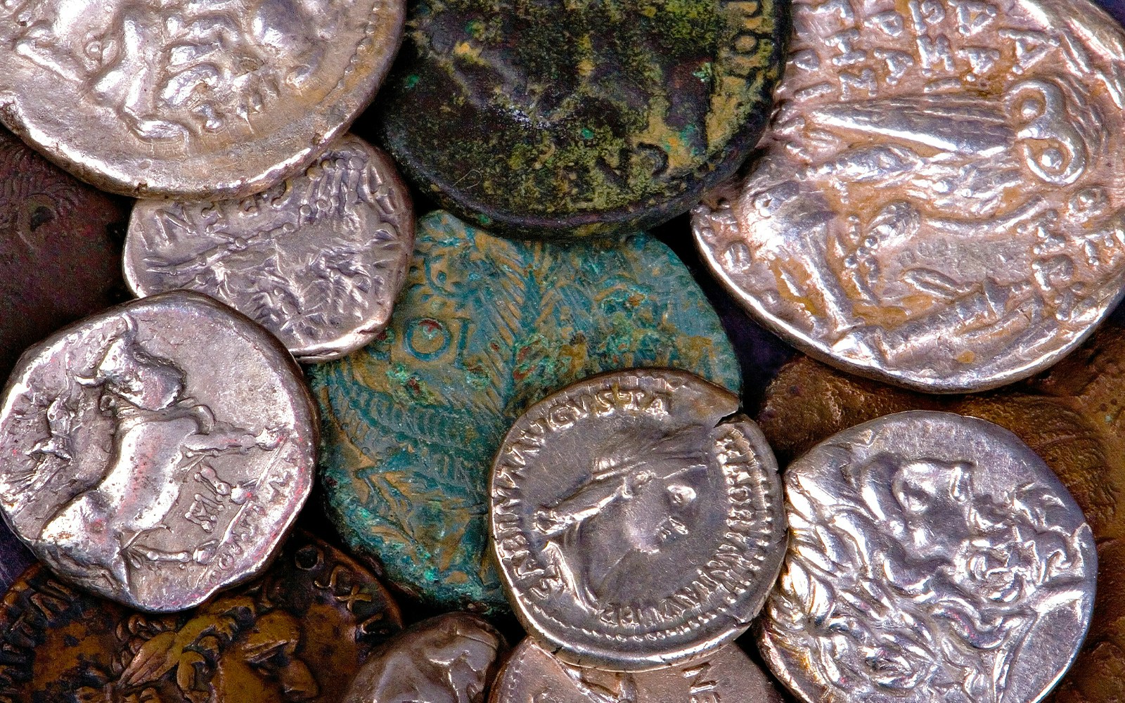 Ancient Roman and Greek coins with detailed engravings.