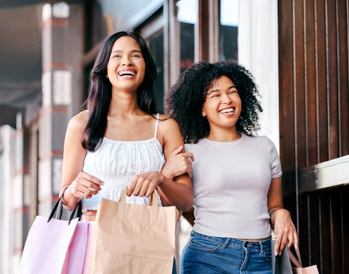 Guests enjoying shopping at American Dream with shopping bags.