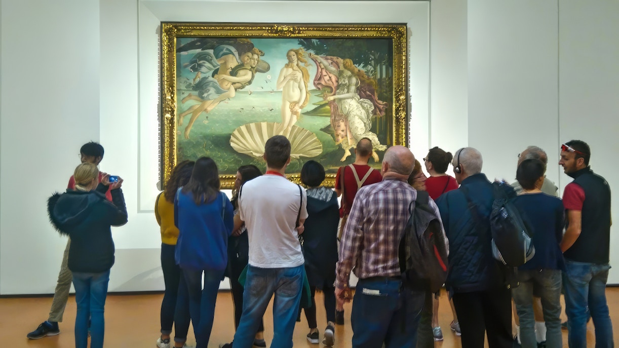Tourists viewing Botticelli's 'The Birth of Venus' at Uffizi Gallery, Florence, with timed entry access.