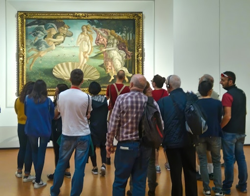 Crowd admiring Sandro Botticelli's painting, capturing the essence of Renaissance art at Uffizi Gallery