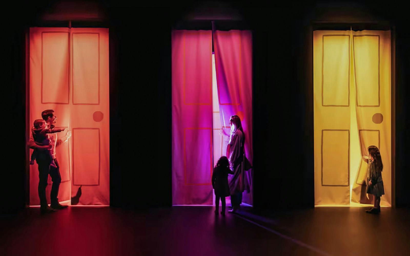 Visitors exploring colorful doorways at Mirror Mirror exhibit, ArtScience Museum.