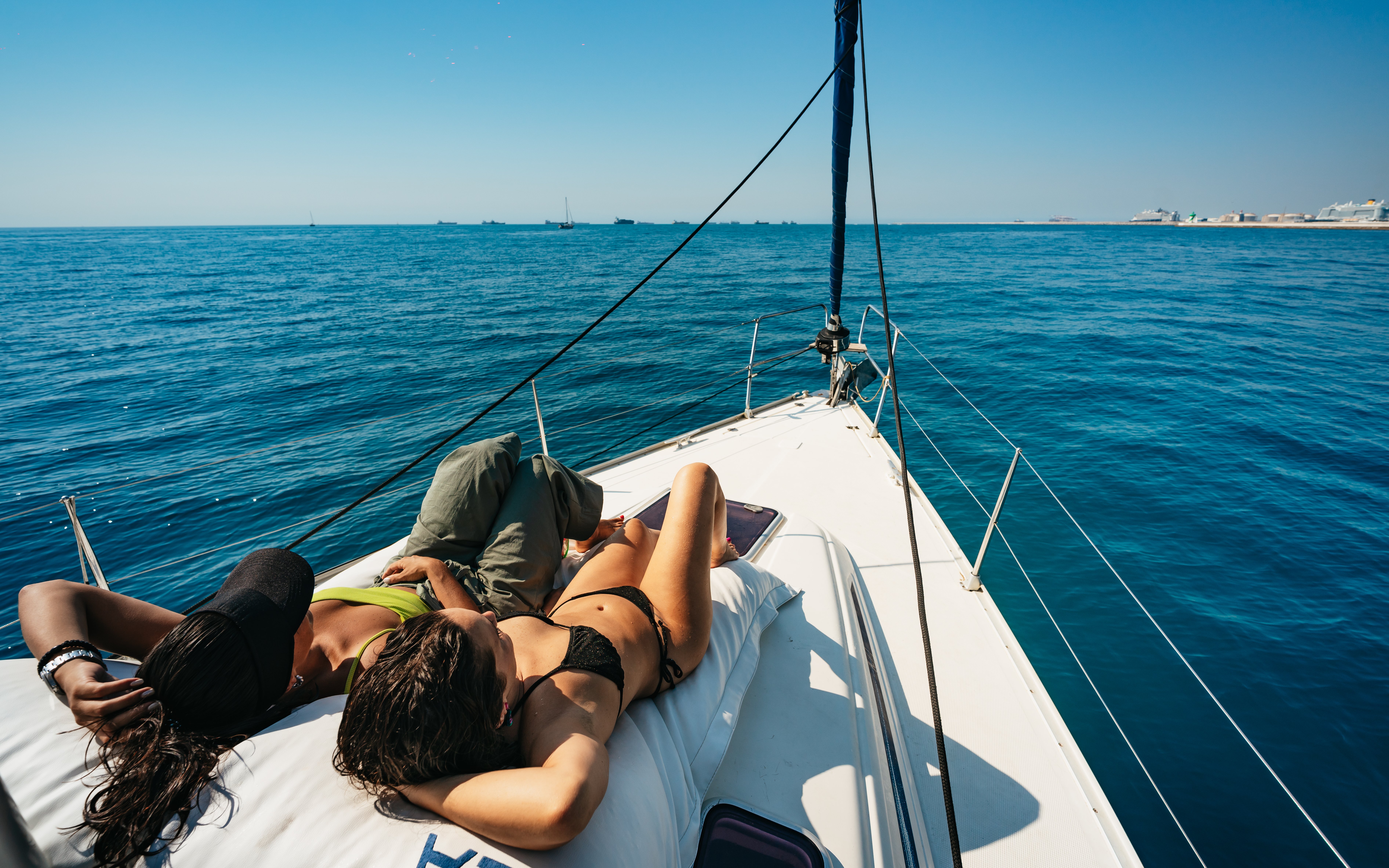 Friends relaxing on a yacht during a Barcelona sightseeing cruise.