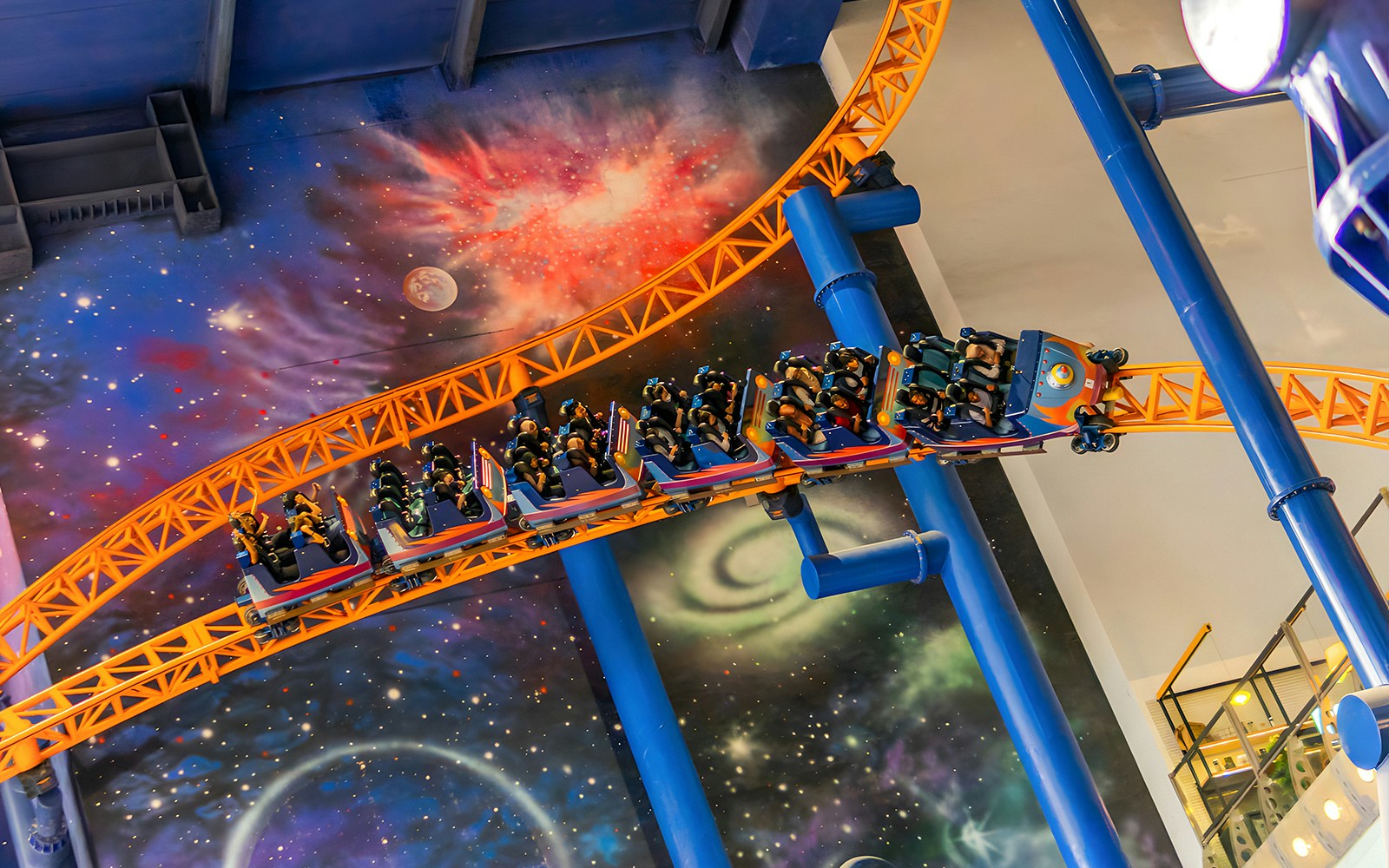 Roller coaster at Berjaya Times Square Theme Park with space-themed backdrop.